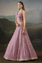 Side view of the baby pink sangeet attire showing the flared georgette skirt, worked border and net dupatta draped behind.