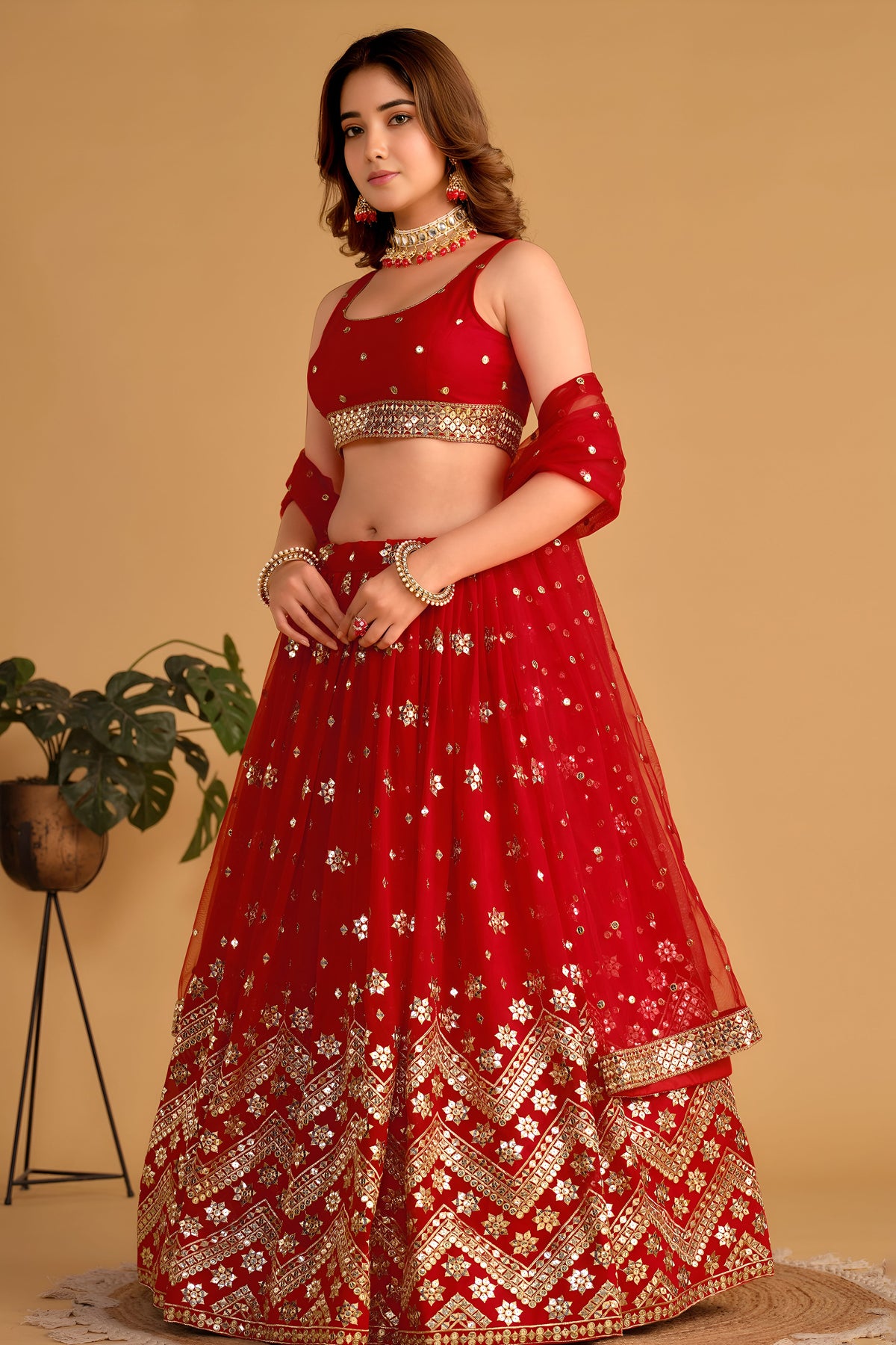 Additional view of a red engagement dresses for women lehenga with zari and sequin embroidery throughout throughout the outfit.