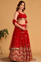 Full-length side view of a red lehenga for wedding with zari and sequin embroidery throughout on the flared lehenga skirt.