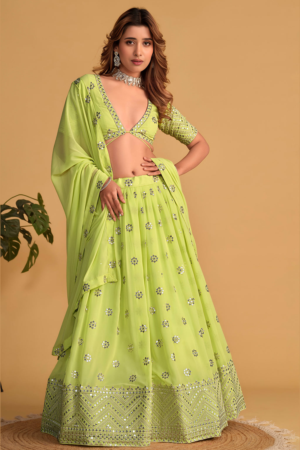 Alternate full-length view of a neon yellow cocktail lehenga with zari and sequin embroidery on the half sleeve choli and lehenga.