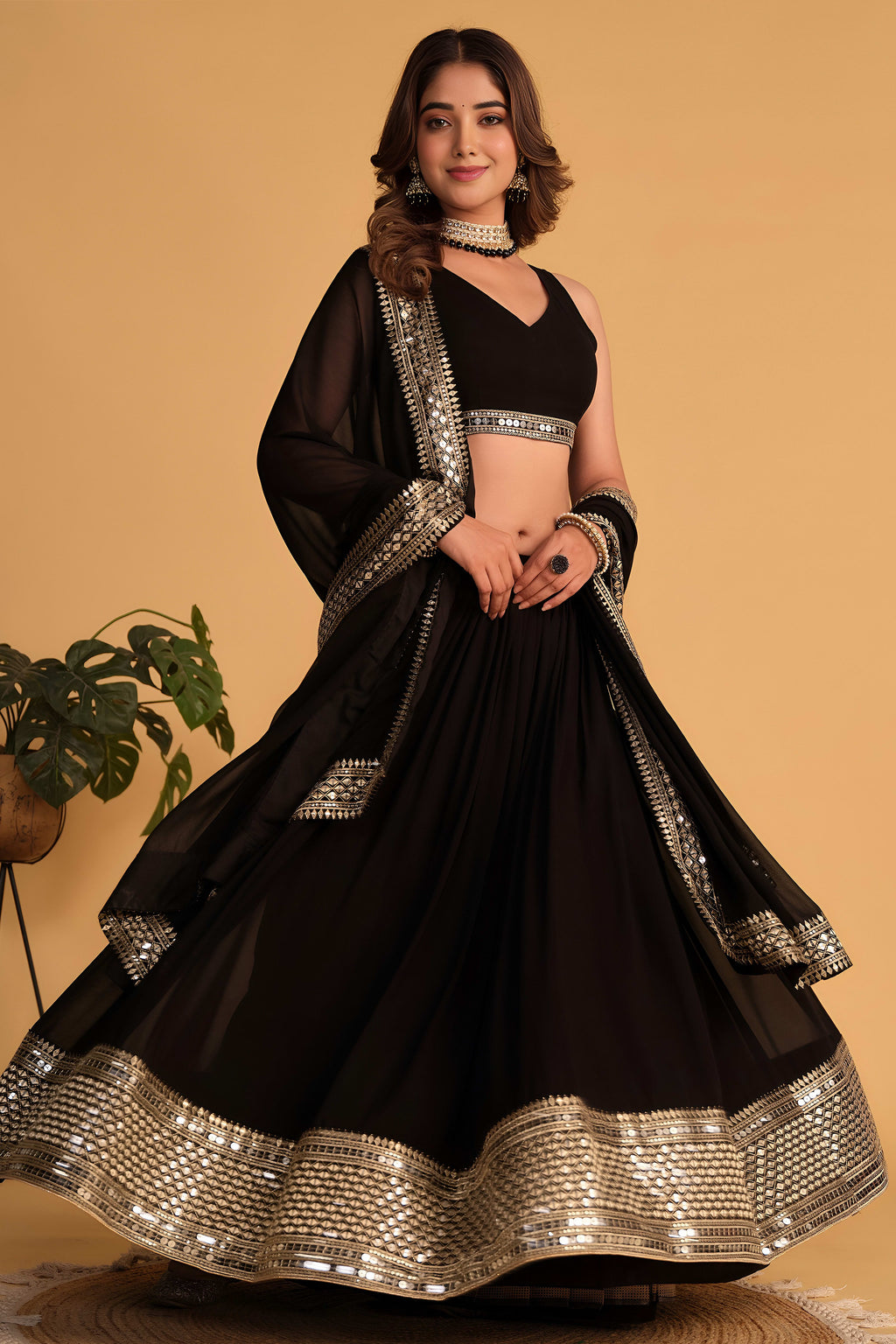 Alternate full-length view of a black sangeet lehenga with zari and sequin embroidery on the sleeveless choli and lehenga.