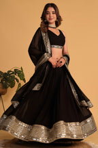 Alternate full-length view of a black sangeet lehenga with zari and sequin embroidery on the sleeveless choli and lehenga.
