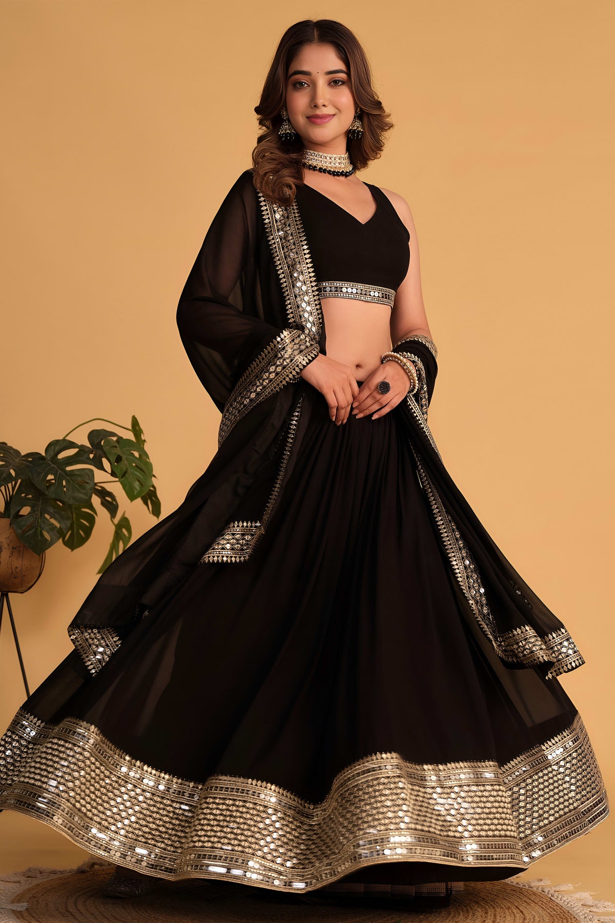 Alternate full-length view of a black sangeet lehenga with zari and sequin embroidery on the sleeveless choli and lehenga.