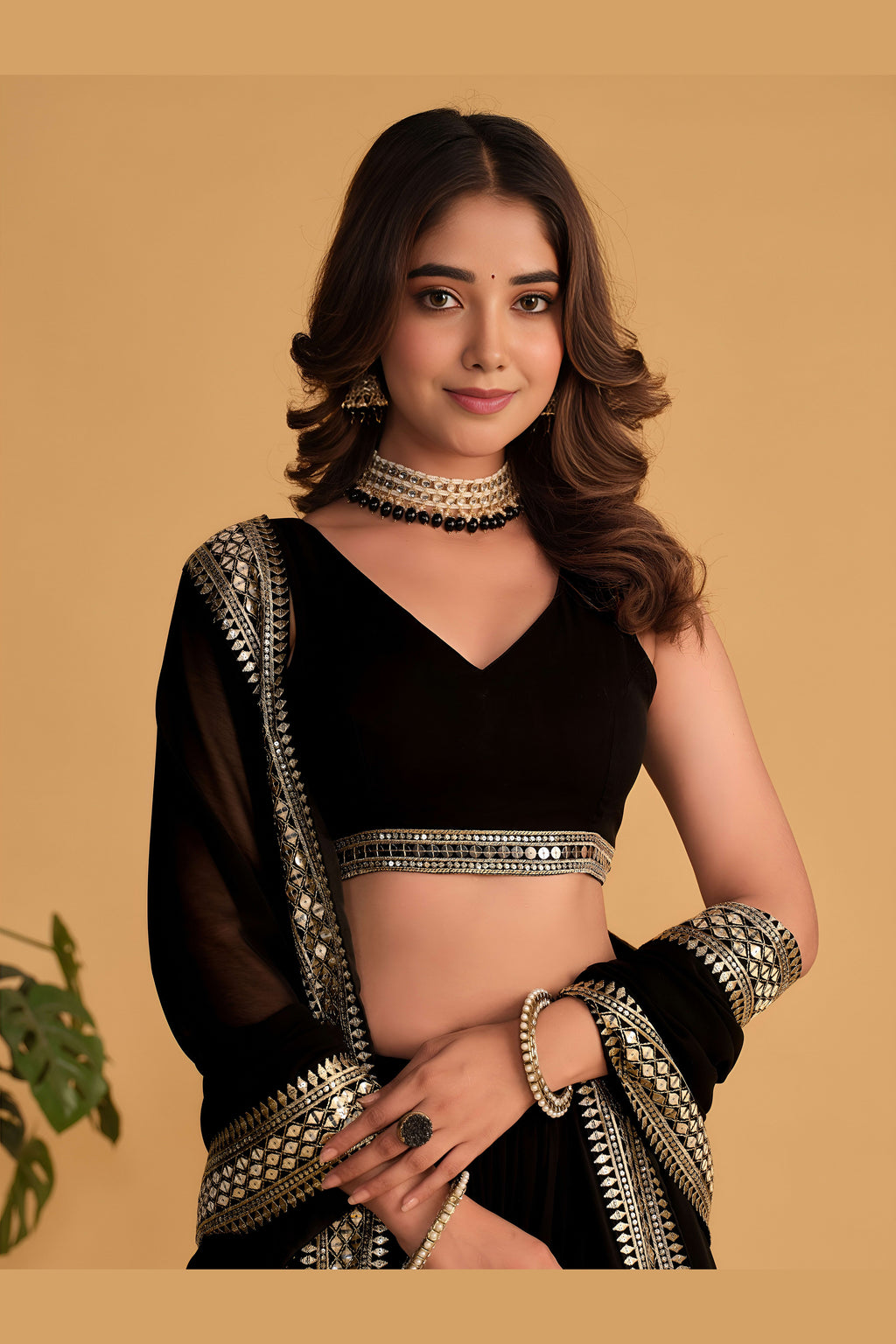 Close-up view of a black engagement dresses for women lehenga with detailed zari and sequin embroidery throughout on the choli.