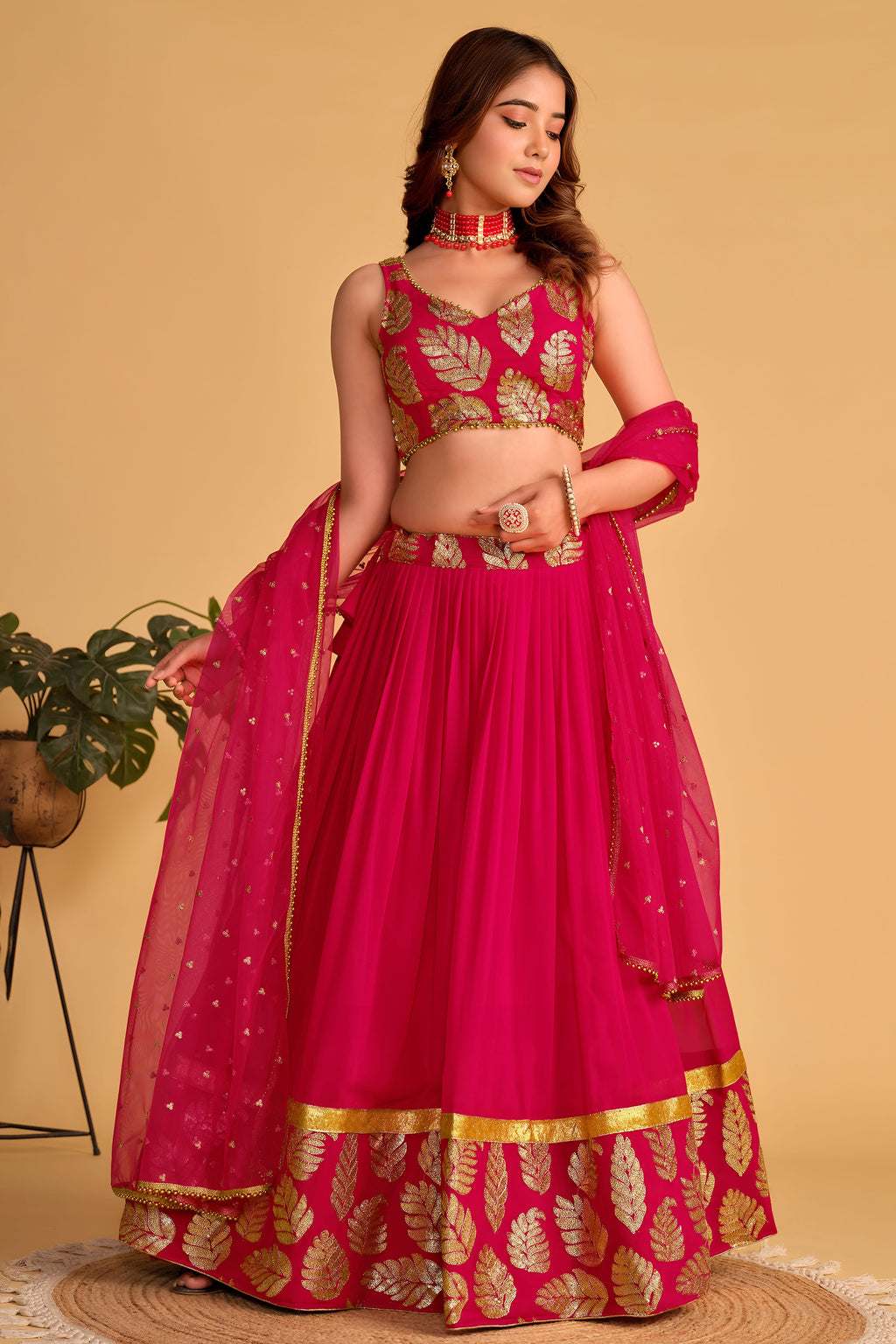 Additional view of a reddish pink engagement dresses for women lehenga with zari and sequin embroidery throughout the outfit.