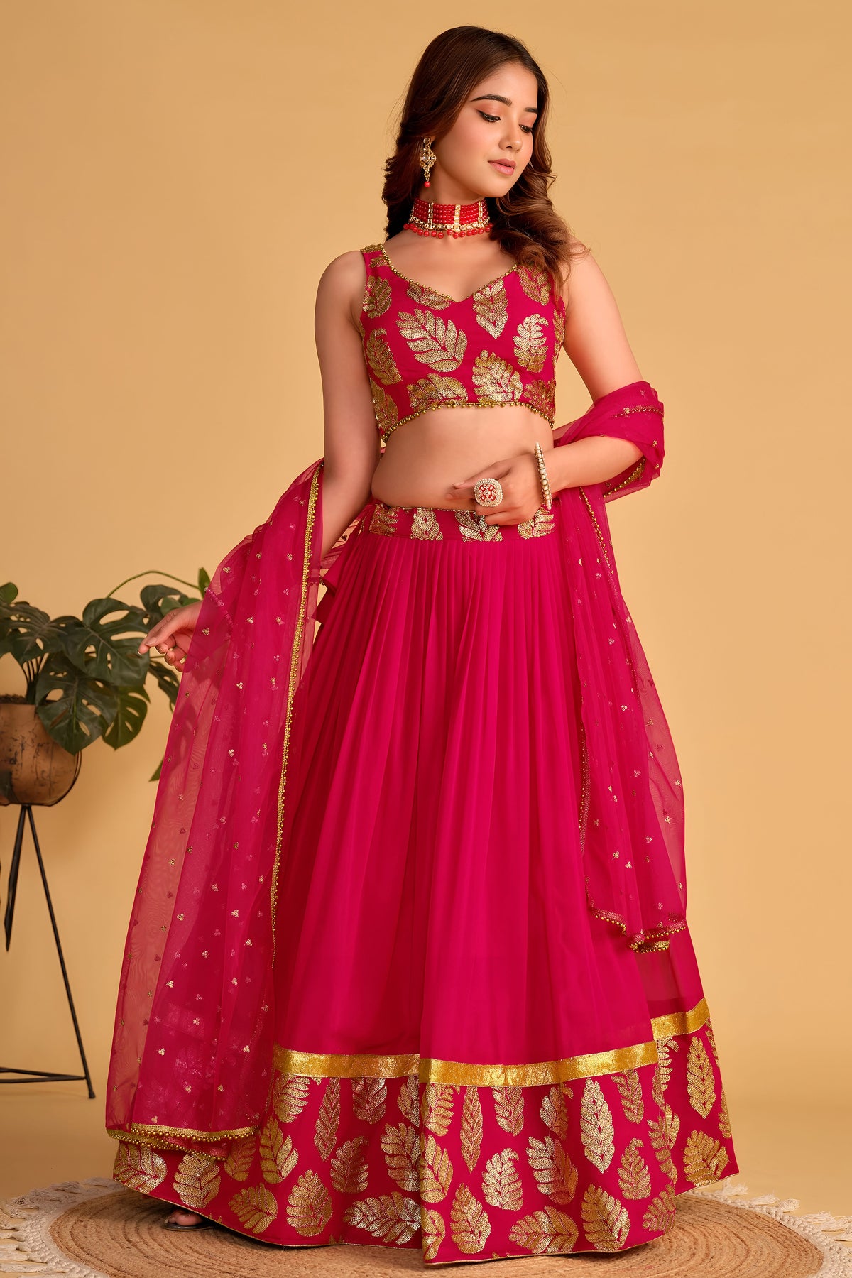 Additional view of a reddish pink engagement dresses for women lehenga with zari and sequin embroidery throughout the outfit.