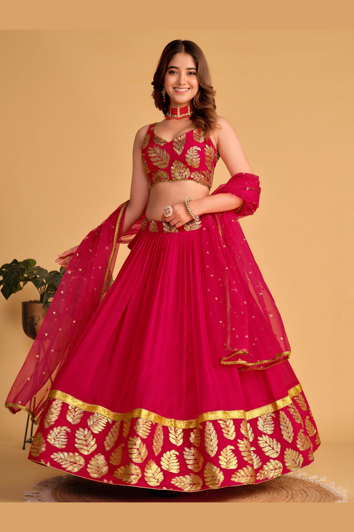 Close-up view of a reddish pink reception lehenga with detailed zari and sequin embroidery work on the sweetheart neck choli.