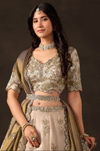 Light beige reception lehenga choli on model, side view displaying flared skirt with embroidery.