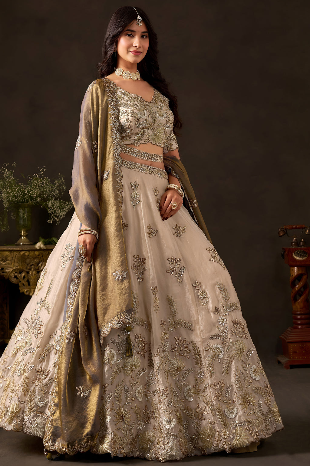 Light beige reception lehenga choli on mannequin, front view with draped dupatta.