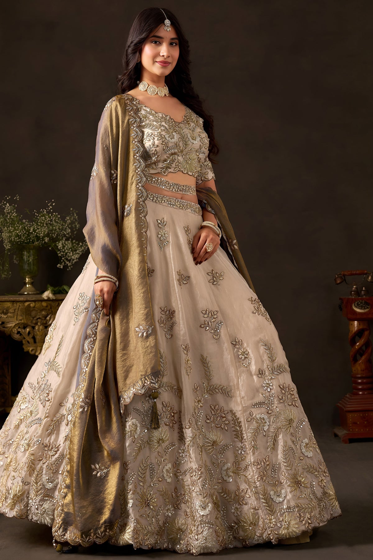 Light beige reception lehenga choli on mannequin, front view with draped dupatta.