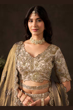 Back side of light beige lehenga choli for wedding, round back neck with zari work.