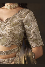 Close-up of light beige wedding lehenga blouse, zari thread and sequin detail on fendy silk.