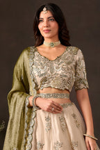 Light beige indian lehenga choli on model, side view displaying flared skirt embroidery.