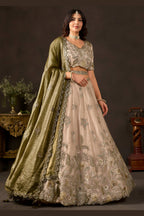 Close-up of light beige sangeet lehenga blouse, zari thread and sequin detail.