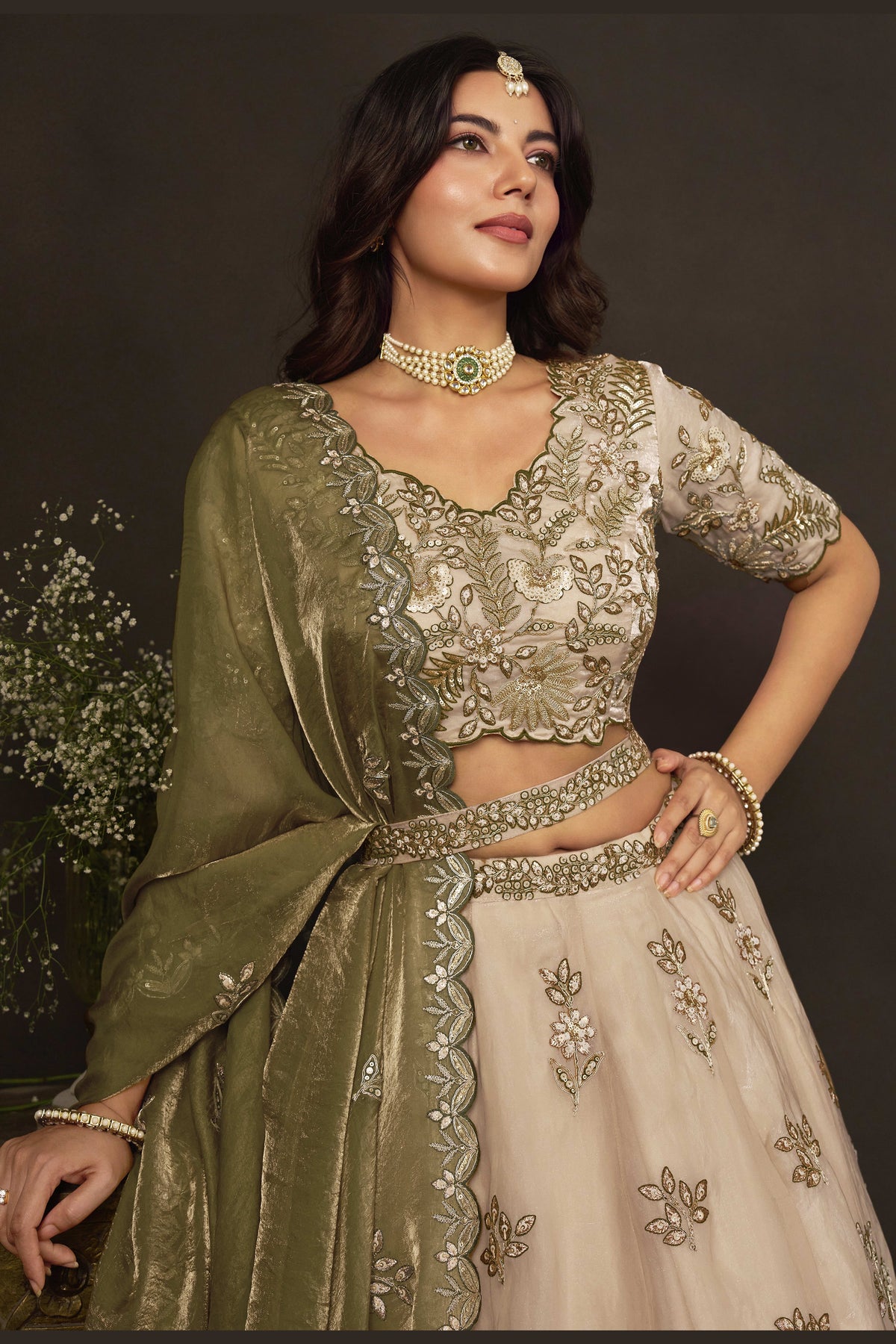 Light beige indian lehenga choli on mannequin, front view with draped dupatta.