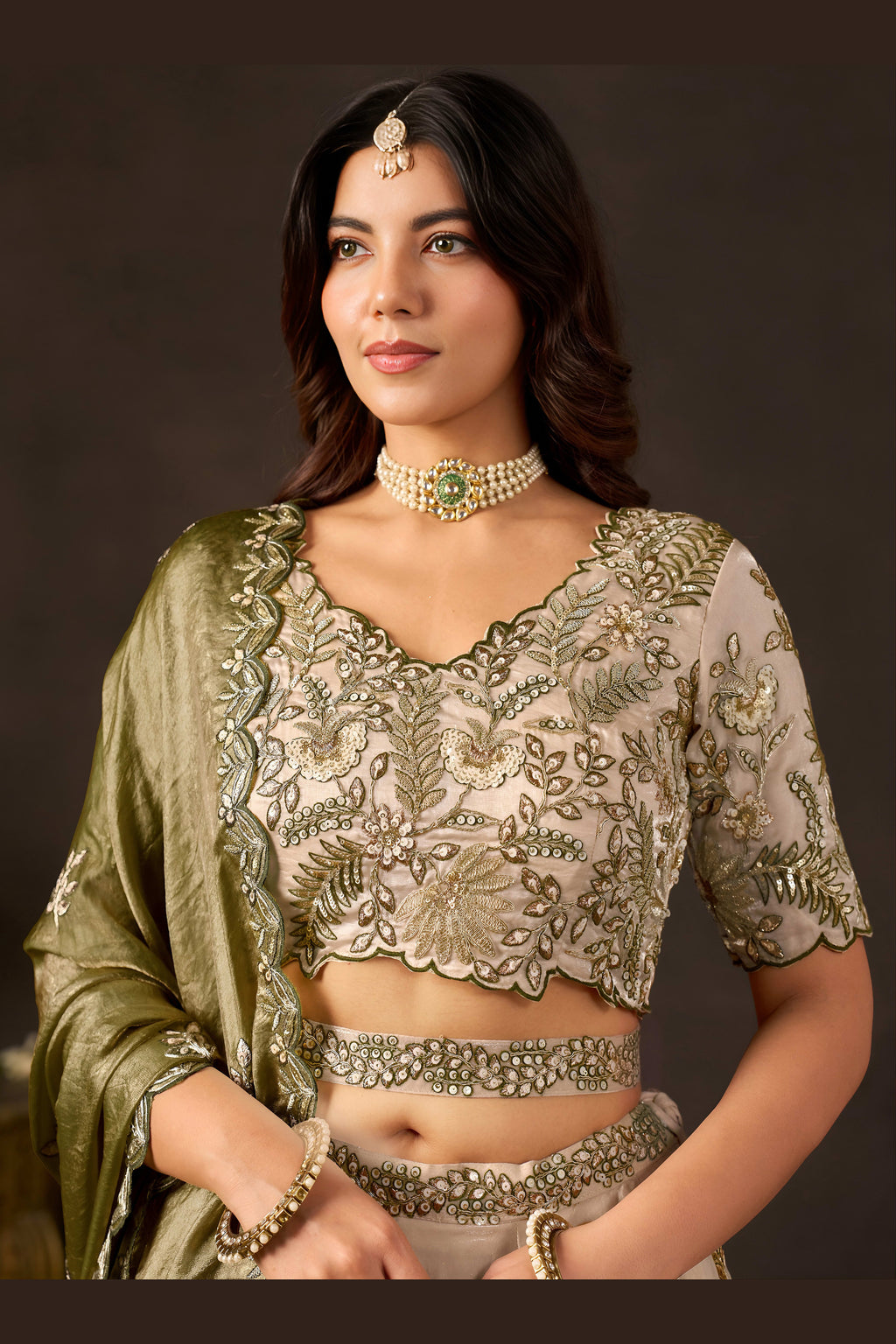 Detail of light beige lehenga choli dupatta edge, zari and sequin border.