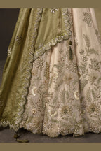 Light beige sangeet lehenga choli with fendy silk dupatta, full length view on model.