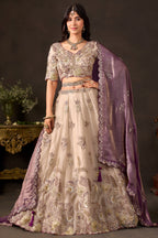Light beige silk lehenga choli, full front view on model, with zari and sequin embroidery.