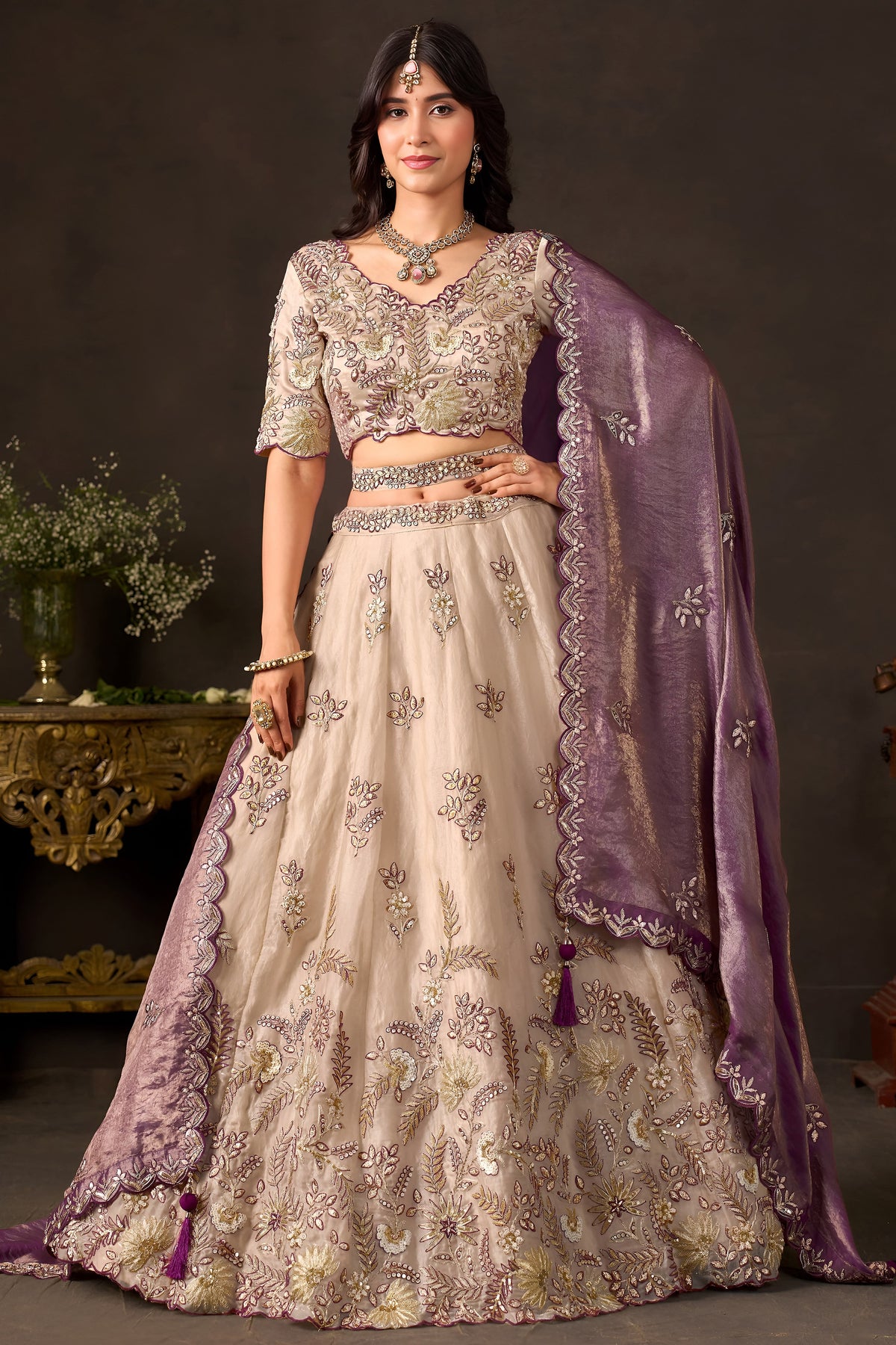 Light beige silk lehenga choli, full front view on model, with zari and sequin embroidery.