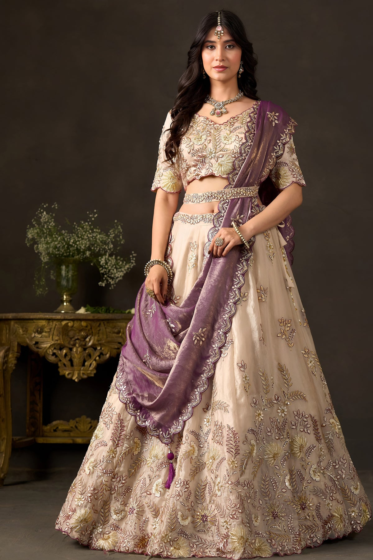 Close-up of light beige silk lehenga blouse, thread and sequin embroidery on fendy silk.