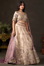 Light beige wedding guest lehenga flat lay, skirt panels with zari floral motifs.