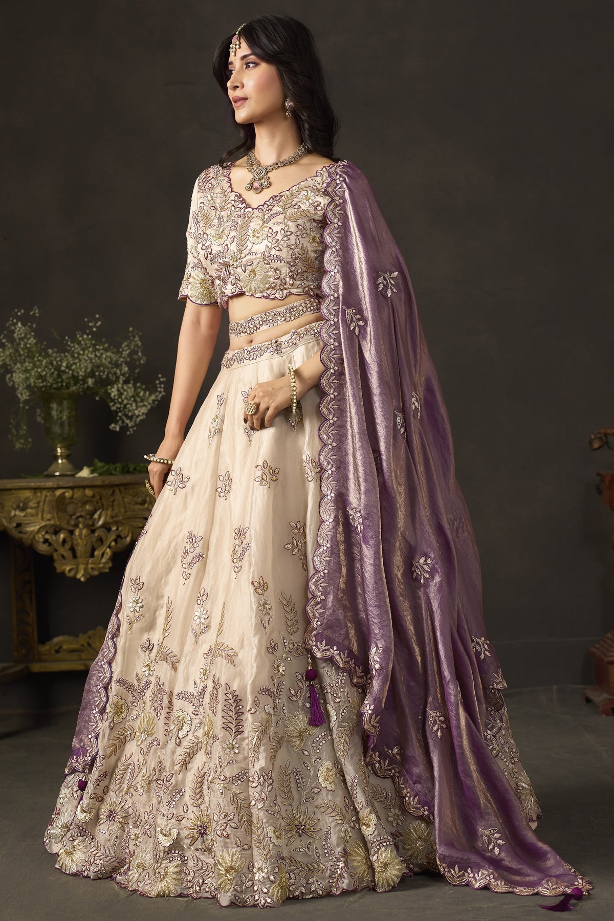 Light beige reception lehenga choli on mannequin, front view with draped dupatta.