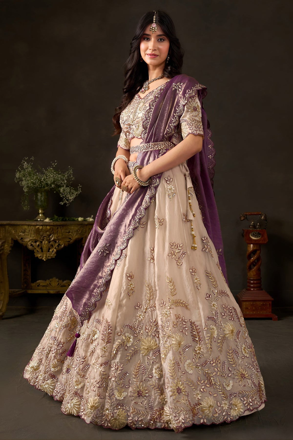 Back view of light beige silk lehenga choli, round back neckline with zari embroidery.