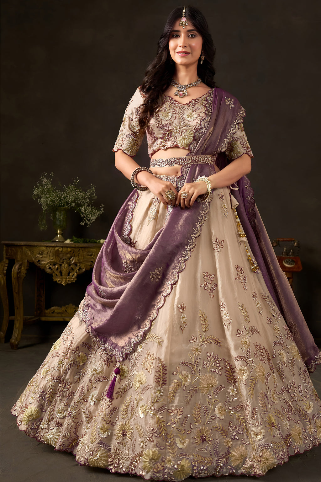 Detail of light beige lehenga waistband, zari and sequin border work on fendy silk.