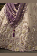 Light beige silk lehenga choli with dupatta, full length view on model with half sleeves.