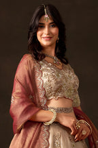 Back view of light beige indian lehenga choli, round neckline with zari embroidery.