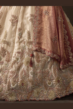 Close-up of light beige indian lehenga blouse, zari and sequin embroidery detail.