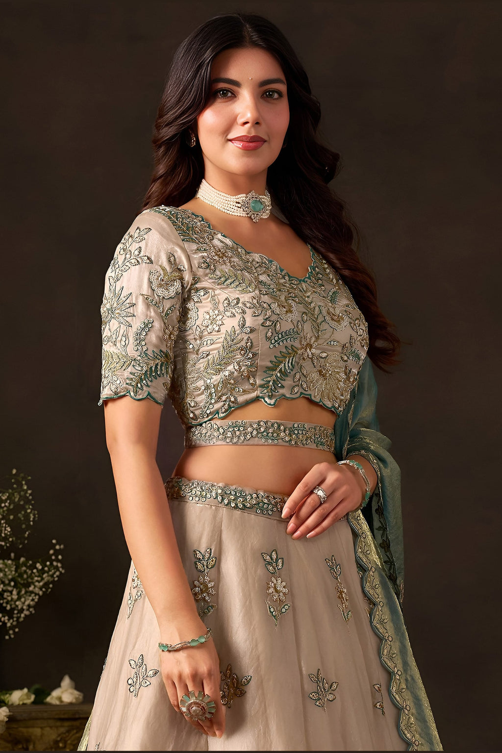 Close-up of light beige lehenga choli blouse, zari and sequin embroidery detail on fendy silk.