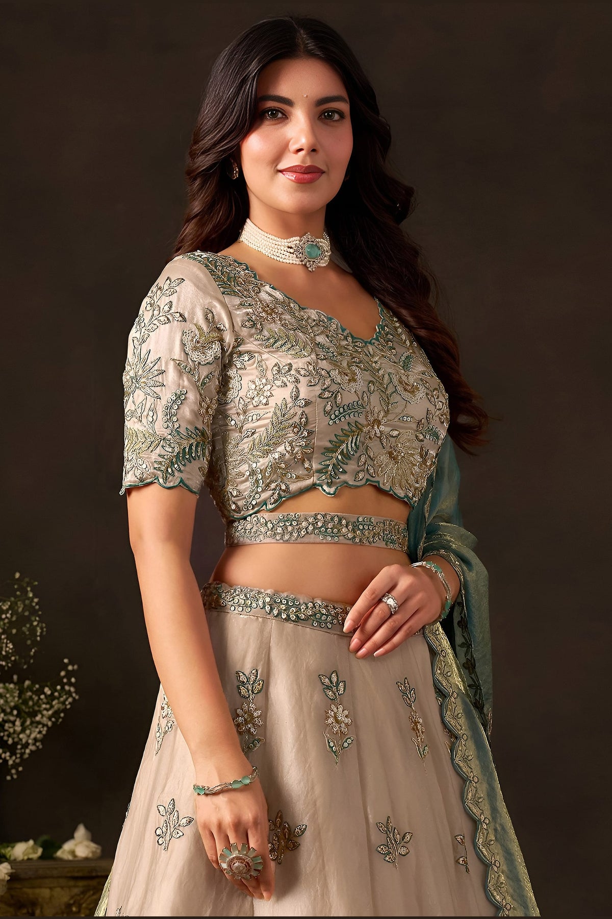 Close-up of light beige lehenga choli blouse, zari and sequin embroidery detail on fendy silk.
