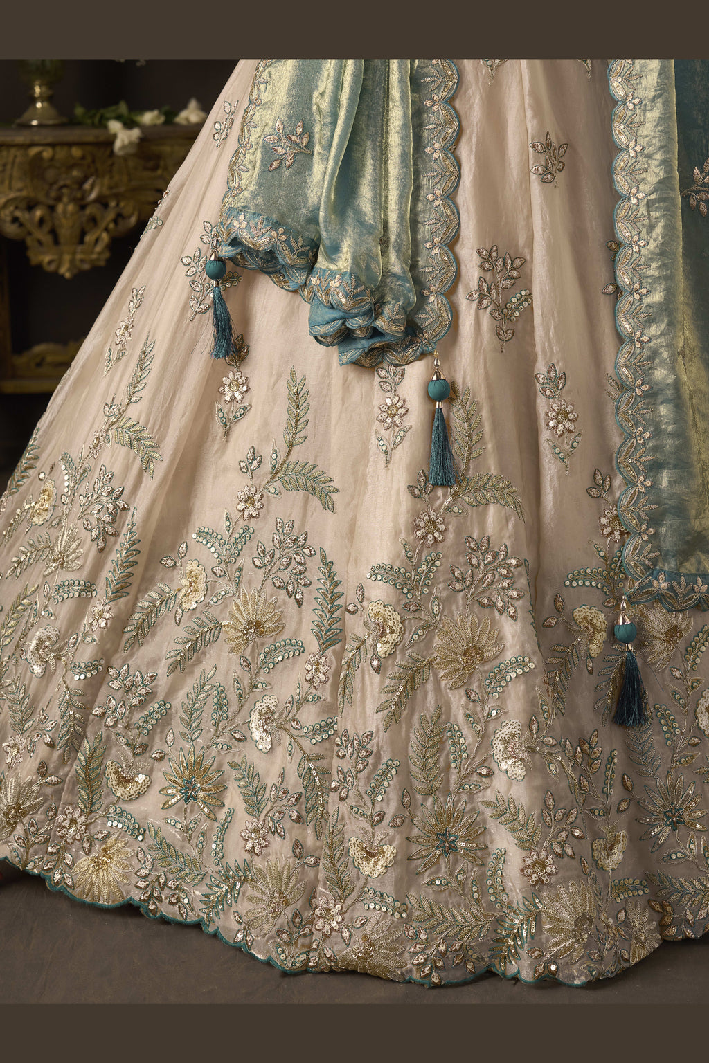 Light beige lehenga choli for sangeet with matching dupatta, full length view on model.