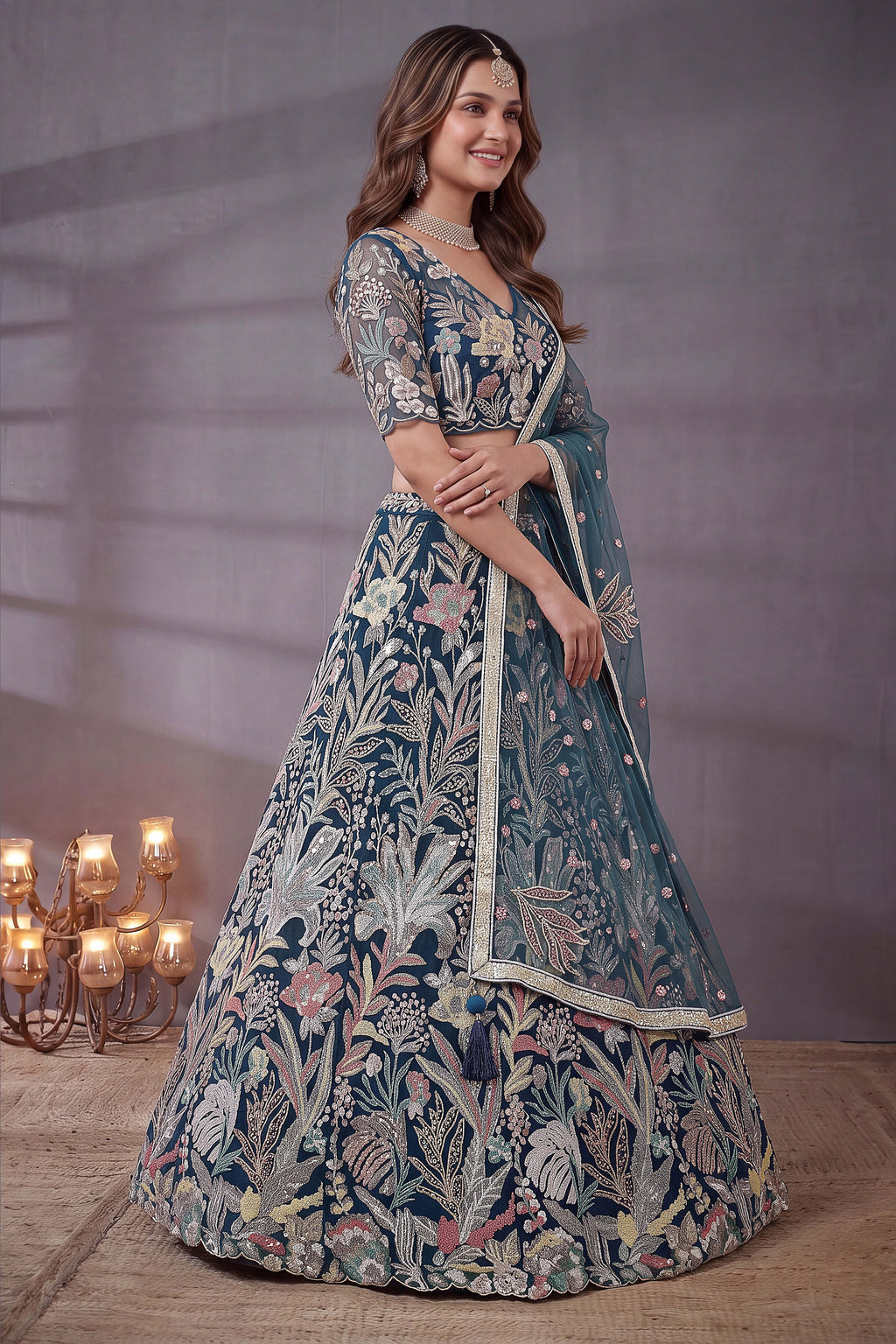 Teal embroidered lehenga, close-up of the lehenga skirt embroidery and sequin work, featuring thread and sequins embroidery work on net fabric.