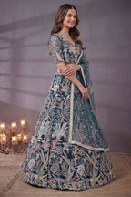 Teal embroidered lehenga, close-up of the lehenga skirt embroidery and sequin work, featuring thread and sequins embroidery work on net fabric.