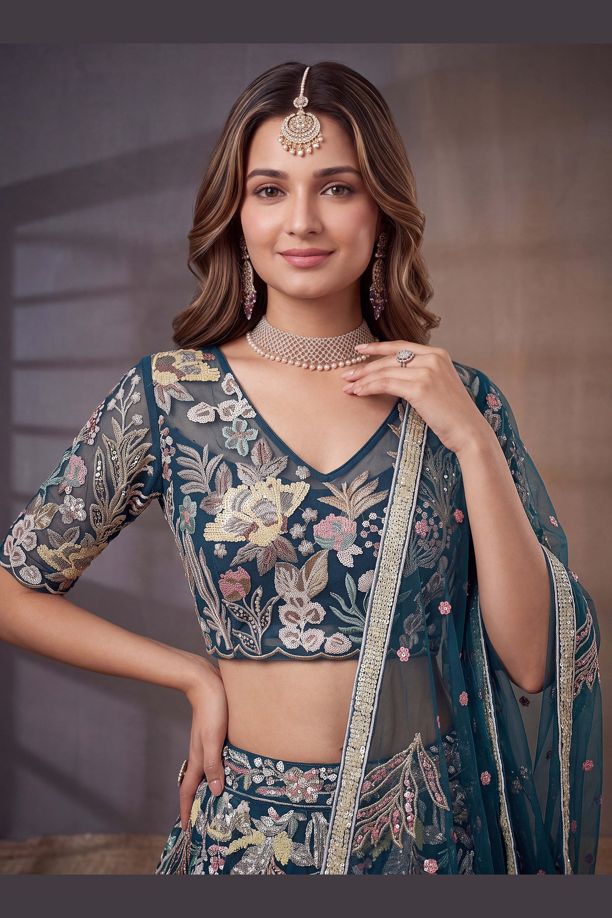 Teal sequin lehenga, detail view of the thread and sequins embroidery on net fabric, featuring thread and sequins embroidery work on net fabric.