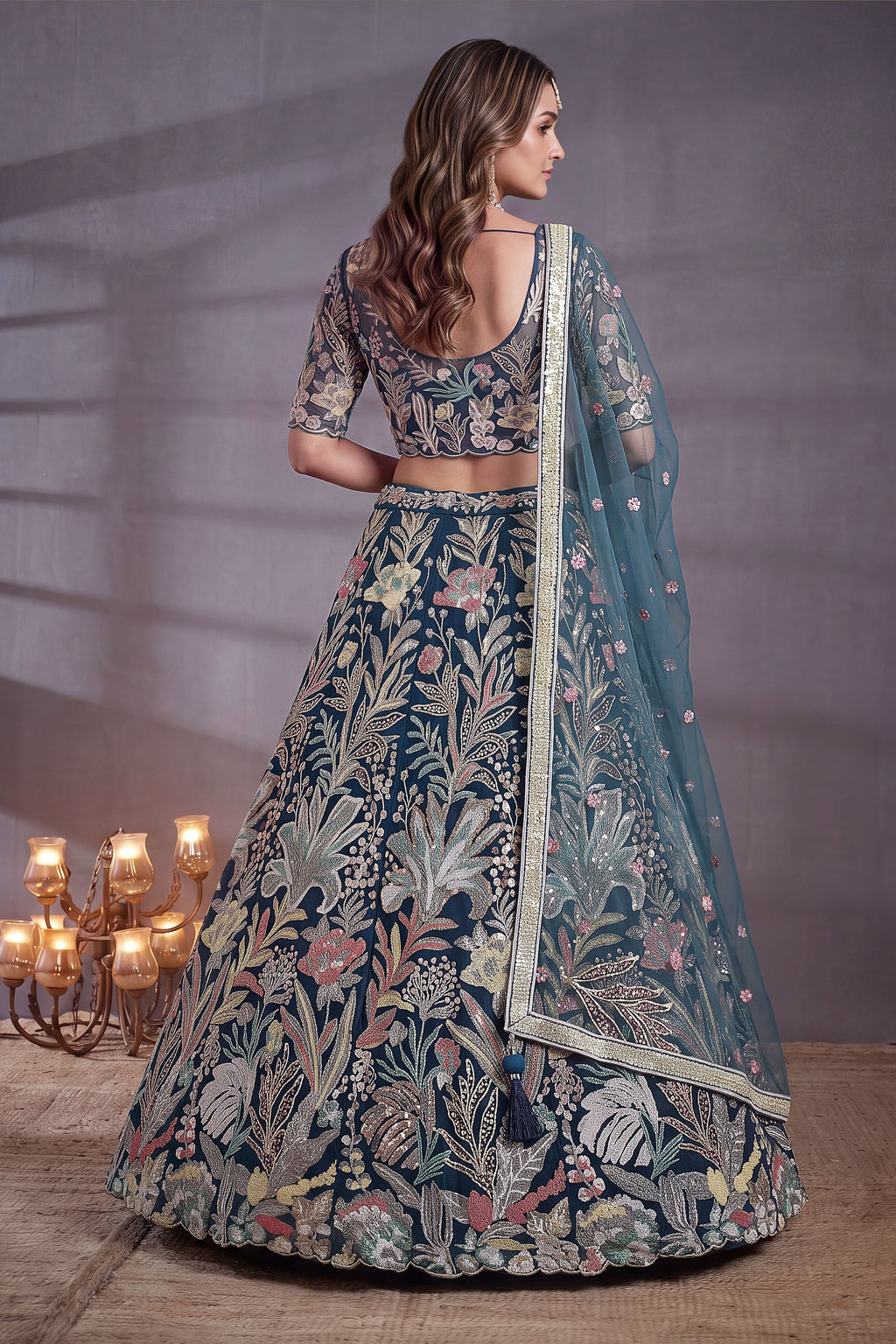 Teal embroidered lehenga, shown from the back view displaying the backside embroidery work, featuring thread and sequins embroidery work on net fabric.