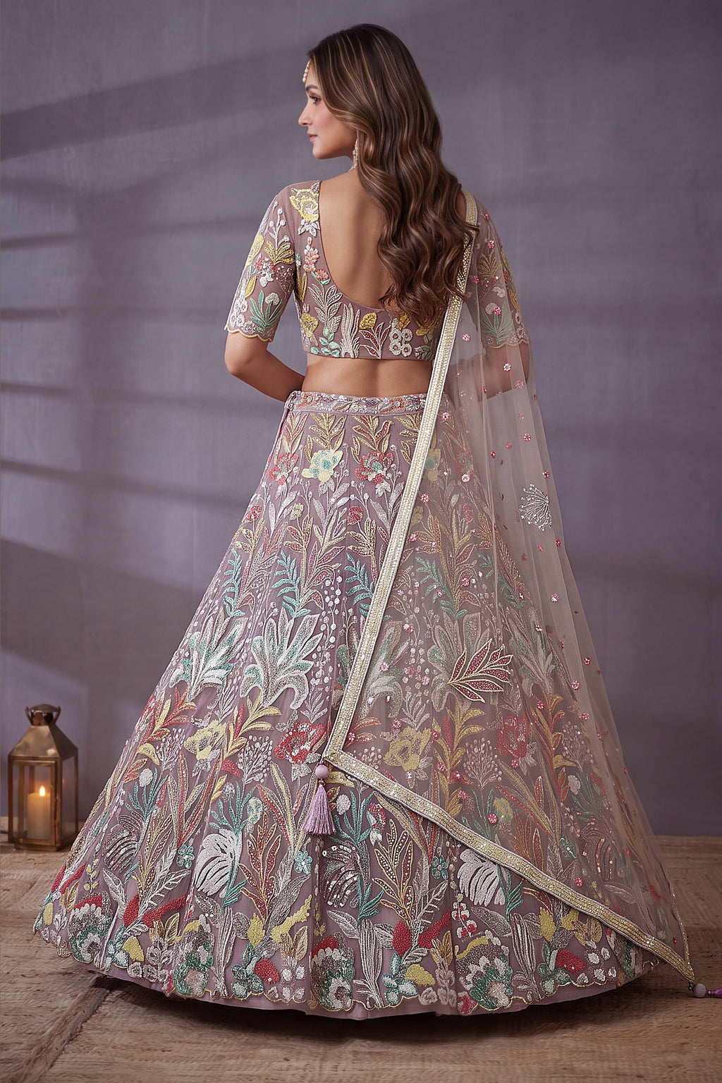 Dusty Rose bridesmaid lehenga, shown from the back view displaying the backside embroidery work, featuring thread and sequins embroidery work on net fabric.