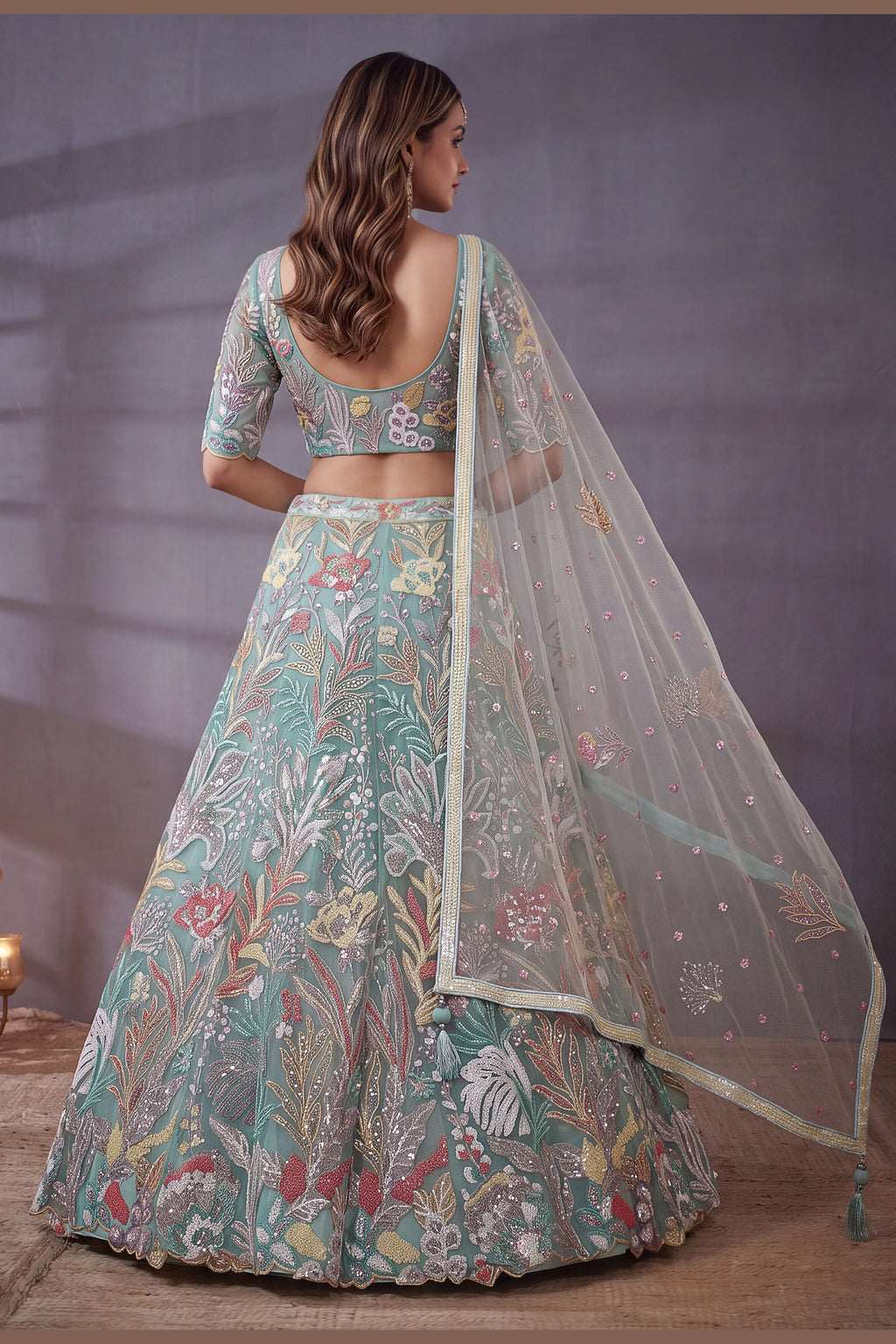 Sky Blue sequin lehenga, shown from the back view displaying the backside embroidery work, featuring thread and sequins embroidery work on net fabric.