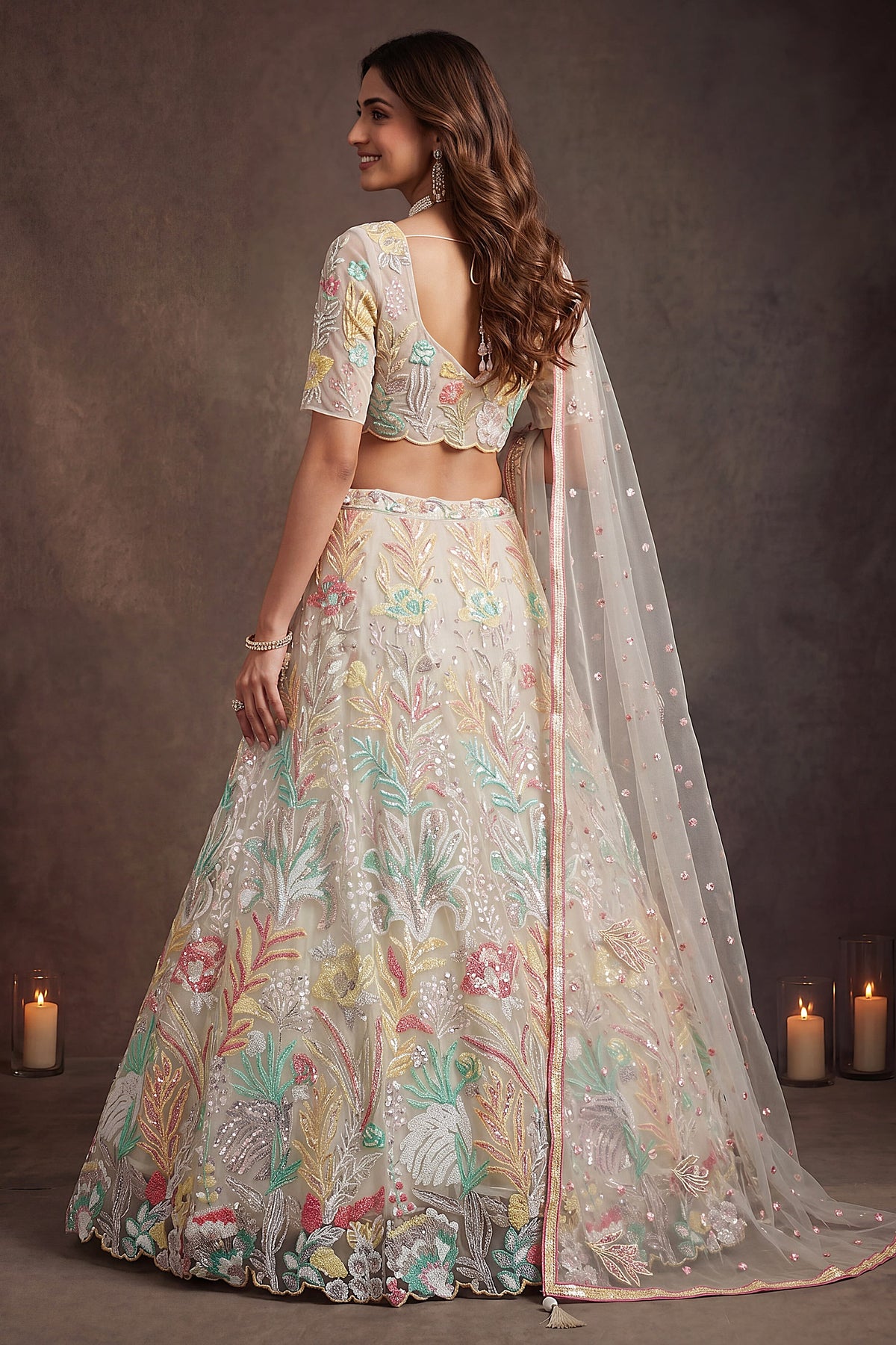 Beige Cream lehenga for diwali, shown from the back view displaying the backside embroidery work, featuring thread and sequins embroidery work on net fabric.