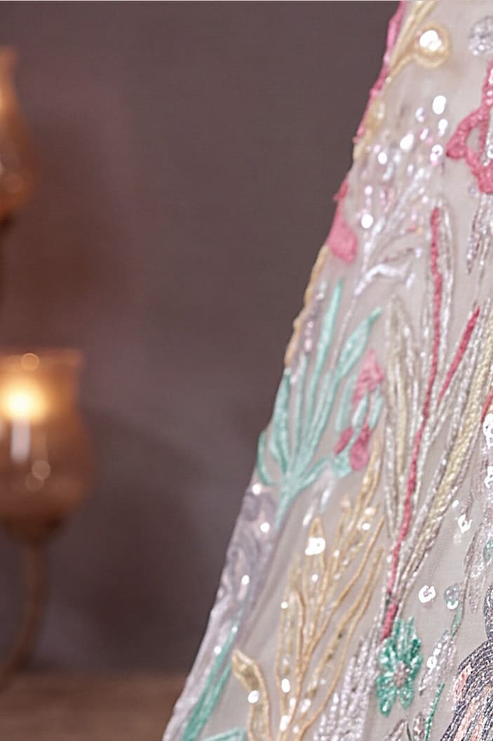 Beige Cream lehenga for diwali, shown with the matching net dupatta draped, featuring thread and sequins embroidery work on net fabric.