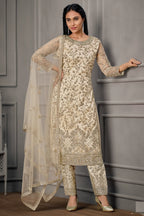 Close-up of embroidery work on cream net kameez with satin pant