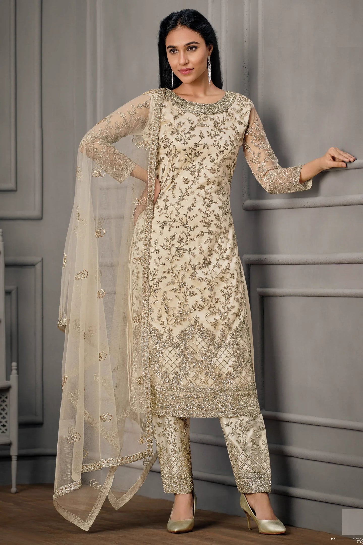 Close-up of embroidery work on cream net kameez with satin pant