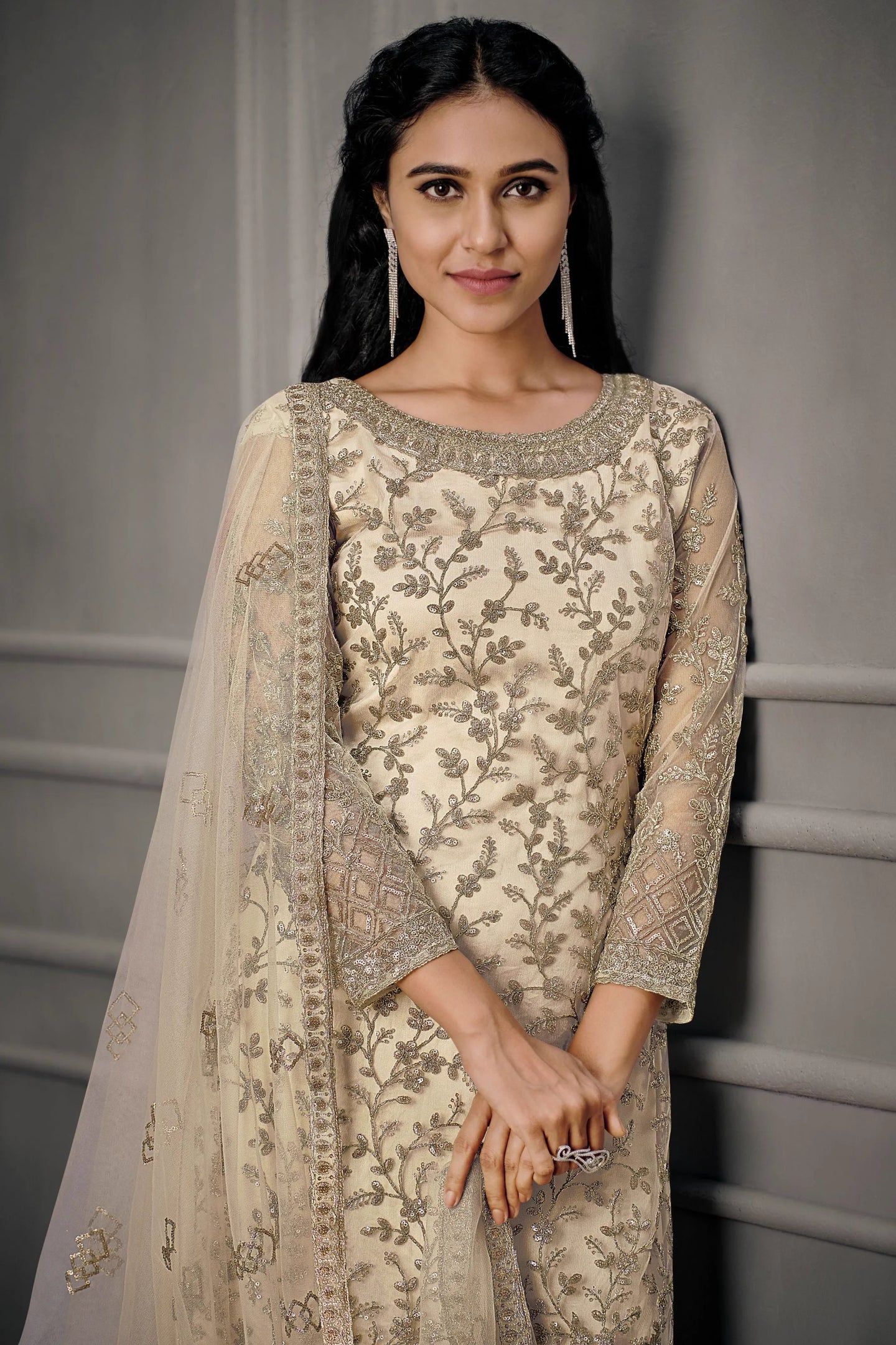 Woman wearing cream net embroidered kameez with pant for Pakistani wedding