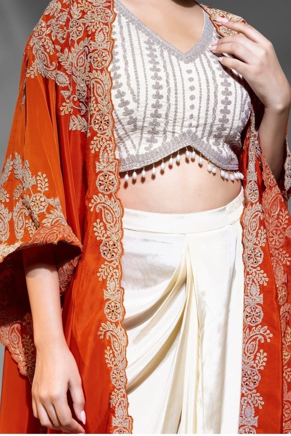 Orange Crepe Blouse With Skirt & Shrug For Indian & Pakistani Wedding Festival - Dori Work, Embroidery Work - hem and footwear detail