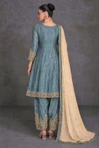 A woman modeling a traditional grey salwar kameez suit with gold embroidery and a cream dupatta, shown from the back against a studio backdrop.